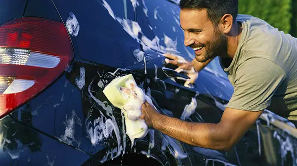 young-happy-man-washing-cars-sponge-how-to-wash-a-car